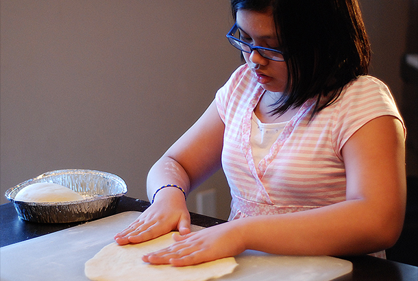Mica kneading the dough.